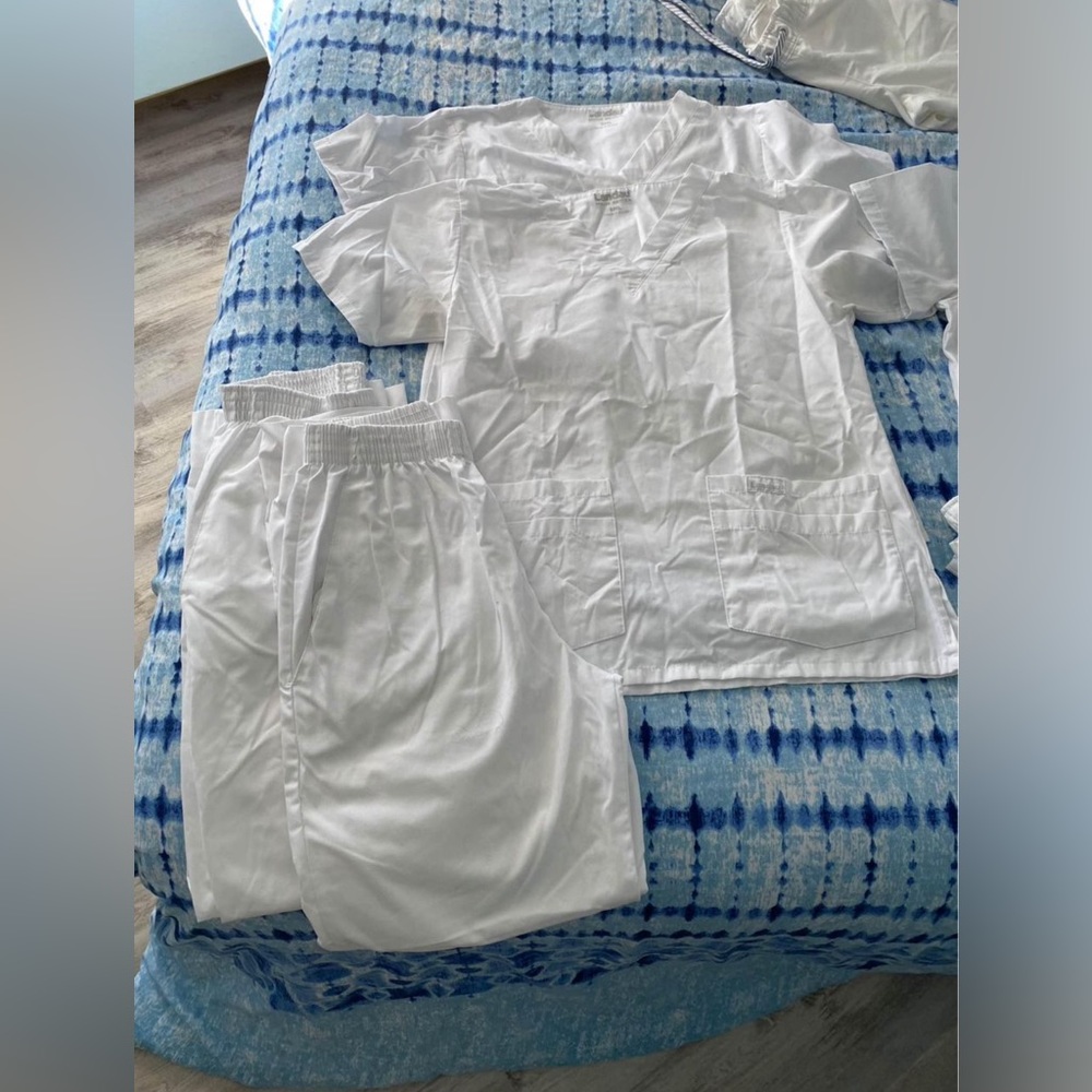 Women’s white scrub tops and bottoms